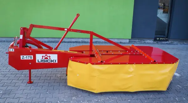 Nowa kosiarka rotacyjna Lisicki Z-178 w kolorze czerwono-żółtym, gotowa do pracy na polu.