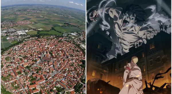 Luftaufnahme einer Stadt mit roten Dächern und einem riesigen Titanen, der über Gebäude ragt. Hier spielt Attack on Titan.