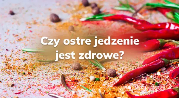 Czerwone papryczki chili i przyprawy rozsypane na stole. Czy ostre jedzenie jest zdrowe?