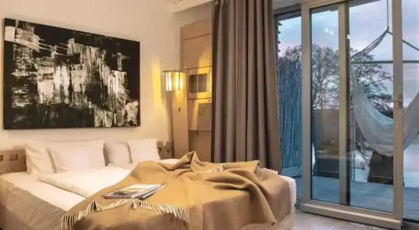 Przytulny pokój w hotelu butikowym. Co to jest? To miejsce z wygodnym łóżkiem, sztuką i widokiem na naturę.