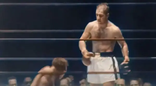 Rocky Marciano, known for his incredible power and fighting spirit, is shown in the ring. His weight was a key factor in his success.