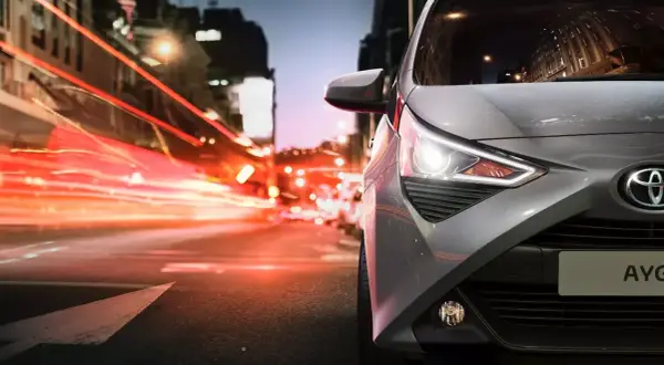 Szare Toyota Aygo 1.0 na nocnej ulicy. Jaki olej silnikowy wybrać, by zapewnić mu płynną jazdę?
