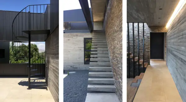 Scale esterne bellissime in metallo nero e cemento, con un design moderno che si integra perfettamente con la pietra naturale e il legno.