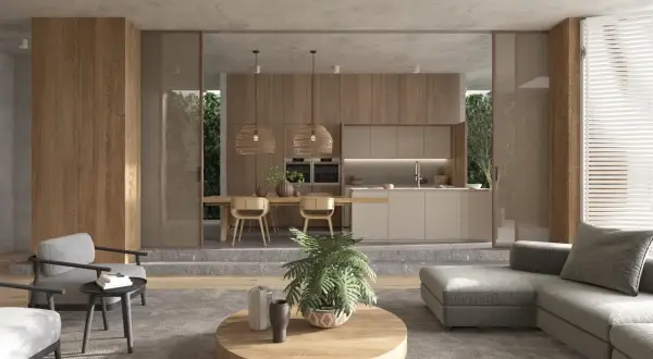 Ein Wohnzimmer mit Essbereich und Küche im Japandi Stil. Natürliche Materialien und dezente Farben schaffen eine ruhige Atmosphäre.
