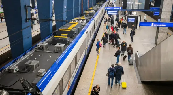 Ludzie z bagażami na peronie czekają na pociąg Intercity. Można zabrać walizki, plecaki i torby.