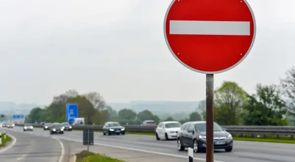 Znak "zakaz wjazdu" ostrzega przed niebezpieczną jazdą pod prąd. Grozi za to wysoki mandat.