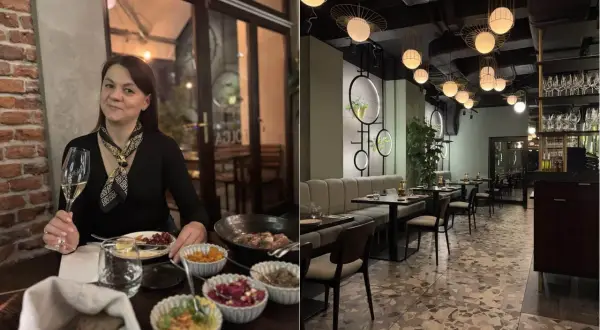 Kobieta z kieliszkiem wina w jednej z ciekawych restauracji okolic Krakowa. Wnętrze lokalu z nowoczesnym designem i stylowymi lampami.