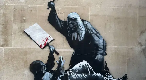 A judge wielding a gavel over a fallen figure, a signature piece by Banksy, questioning justice.