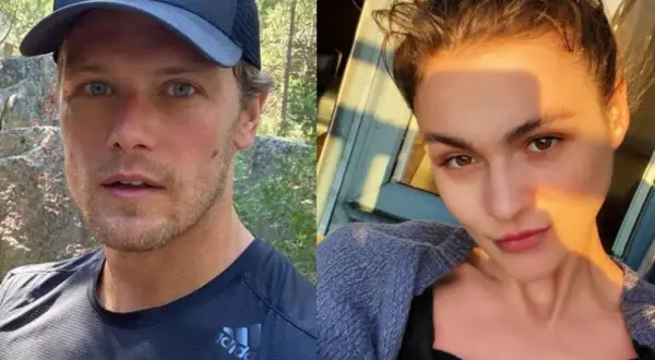 Sam Heughan, con gorra y camiseta deportiva, y una mujer con el pelo recogido y un suéter azul. Podrían ser una pareja.