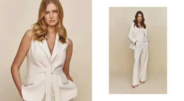 Elegancka stylizacja z białą marynarką bez rękawów i szerokimi spodniami. Druga modelka prezentuje komplet z białą marynarką.