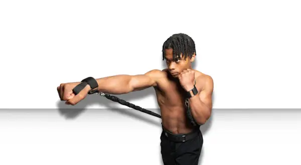 A boxer trains to punch faster using resistance bands attached to his wrists, building explosive power.