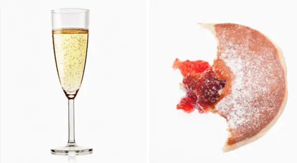 Glas Prosecco und ein angebissener Krapfen mit Marmelade. Über Prosecco Kalorien muss man sich hier wohl keine Gedanken machen.