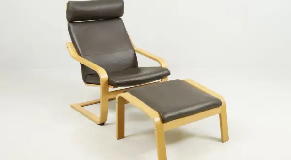Brown leather armchair with a matching ottoman, featuring bentwood frames.