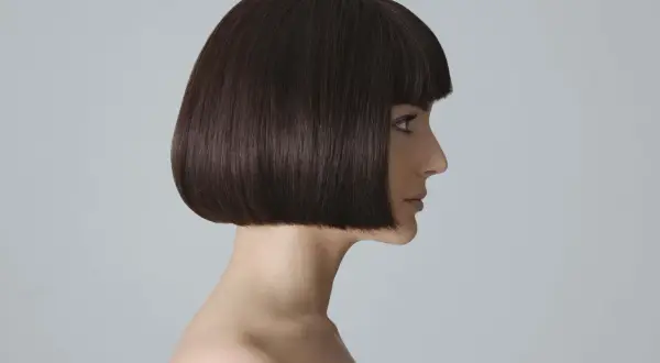 Profilo di donna con french bob scuro e netto. Un taglio che valorizza i lineamenti, un classico intramontabile.