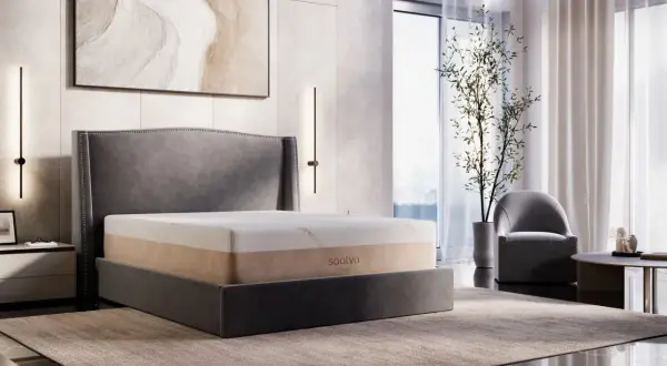 A Saatva memory foam mattress on a bed, showcasing its durability and comfort in a modern bedroom setting.