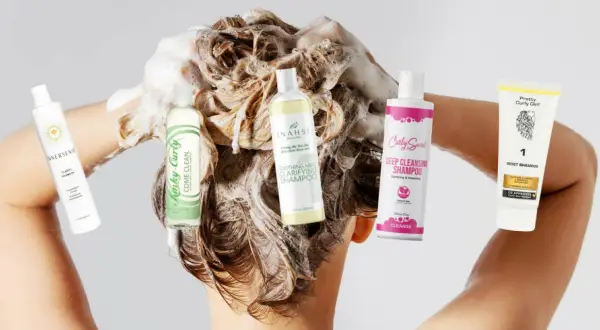 Fünf verschiedene Shampoos, darunter ein Tiefenreinigungsshampoo, werden in schaumiges Haar gehalten.