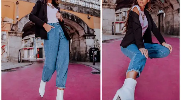 Eleganckie stylizacje z jeansami: kobieta w czarnym blazerze, białej koszulce i luźnych jeansach, uzupełnione białymi botkami na obcasie.