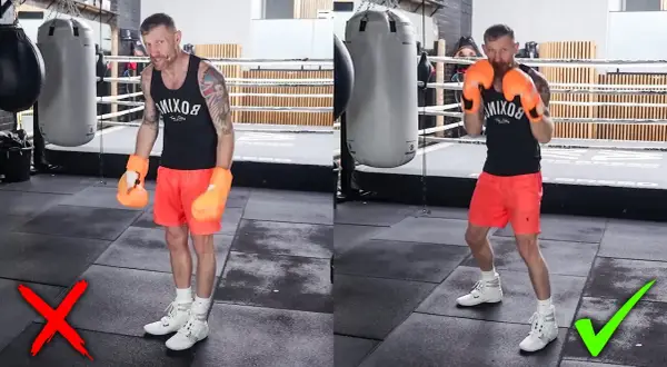 Boxer demonstrates the correct stance for a right hook, showing proper footwork and guard.