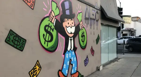 A vibrant graffiti drawing of the Monopoly Man, clutching bags of money, stands proudly on a wall. Dollar bills rain down around him, a testament to his wealth.