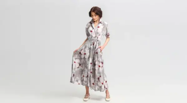 Elegancka sukienka w kwiaty, idealna odpowiedź na pytanie jak się ubrać na wesele po 50. Lekki materiał i stylowy krój.