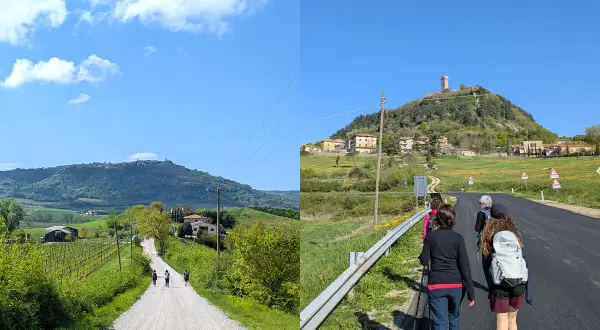 Pellegrini sulla Via Francigena, un cammino che porta verso un borgo arroccato su una collina, evocando il suo antico significato.
