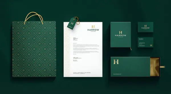 A sophisticated brand identity featuring a monogram logo with the letter "H" on a shopping bag, stationery, and packaging.