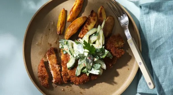 Krispigt schnitzel recept med klyftpotatis och krämig gurksallad. En perfekt middag!