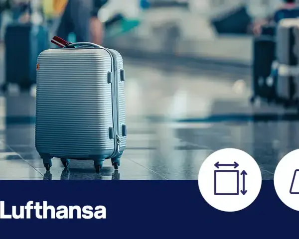 Srebrna walizka podręczna na lotnisku, logo Lufthansa, ikony wymiarów i wagi.
