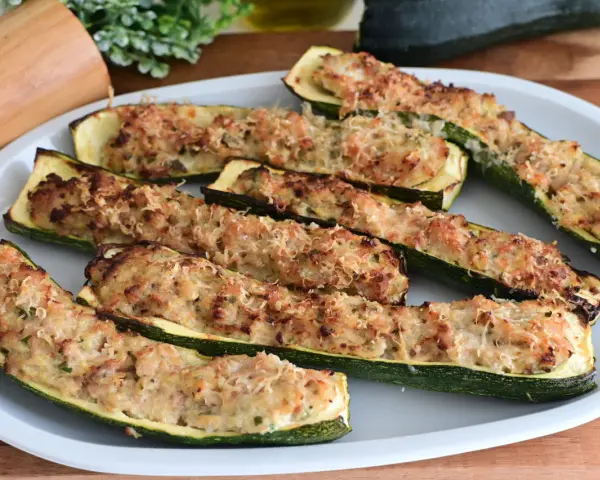 Zucchine ripiene in padella, dorate e gratinate, pronte per essere gustate.