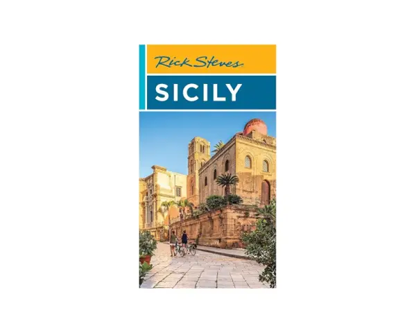 Rick Steves Sicily: A sun-drenched street in Sicily with ancient architecture and two people on bicycles, hinting at an unforgettable journey.