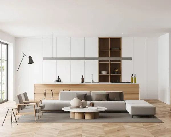 Interni luminosi con divano, tavolino e cucina a vista. Un esempio di come arredare case moderne con stile e funzionalità.