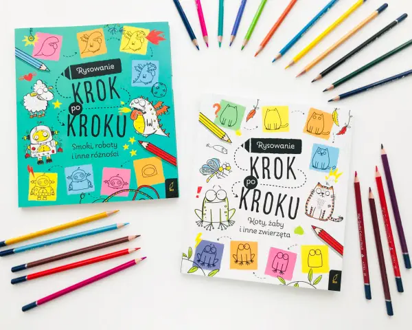 Dwie książki "Rysowanie Krok po Kroku" zachęcają do nauki rysowania smoków, robotów i zwierząt. Kolorowe kredki leżą obok, gotowe do tworzenia.