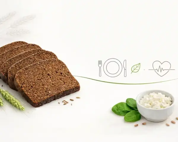 Plasterki pumpernikla, ser biały, liście szpinaku i symbole zdrowego odżywiania. Pumpernikiel kcal - zdrowy wybór.