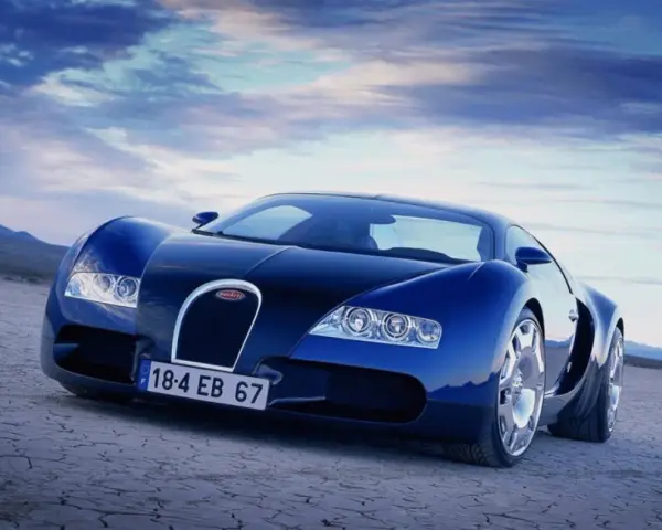 Niebieski Bugatti Veyron na pustynnym tle pod błękitnym niebem.