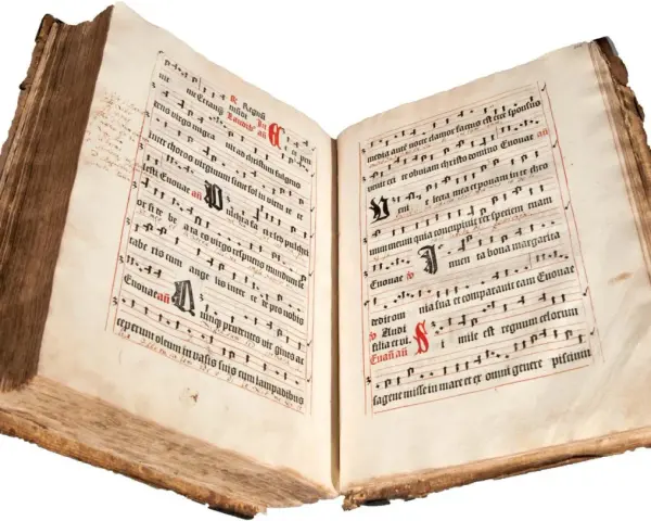 An ancient illuminated manuscript, its pages filled with musical notation and text, evokes the divine hours.