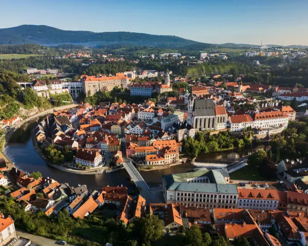 Widok na malowniczy Czeski Krumlov, gdzie rzeka Vltava otacza zabytkowe centrum z zamkiem i kościołem. To idealne miejsce, by odkrywać czeski krumlov atrakcje.