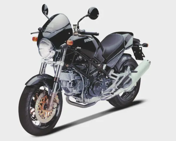 Czarny Ducati Monster z owiewką i sportowym wydechem. Klasyka motoryzacji, która wciąż budzi emocje.