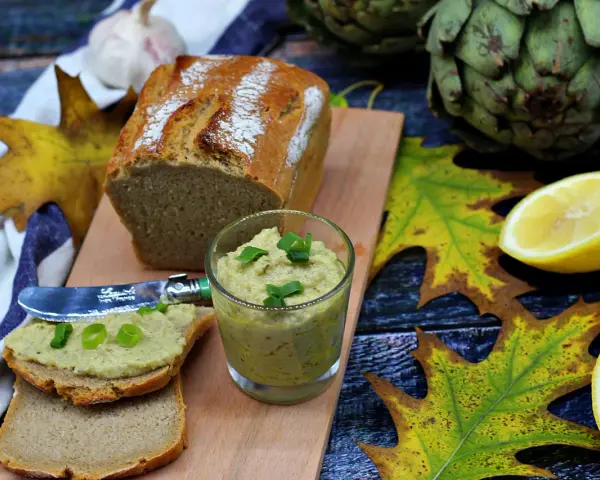 Pesto z karczocha idealne na jesienne kanapki. Podane z chlebem, cytryną i karczochami.