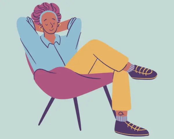 A person relaxes in a chair, hands behind their head, demonstrating how to decompress.