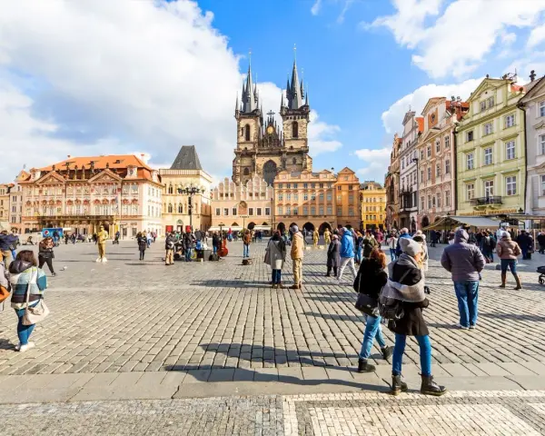 People enjoy Prague tours in Old Town Square, with the Church of Our Lady before Týn dominating the skyline.