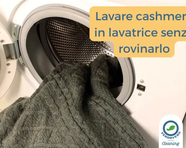 Un maglione di cashmere grigio viene inserito in una lavatrice. Impara come si lava il cashmere in lavatrice senza rovinarlo.