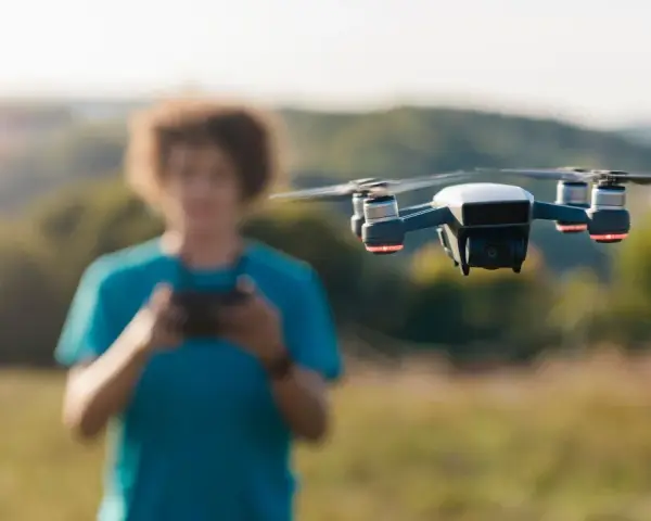 A person controls a drone, unaware of the potential penalty for flying a drone without a license.