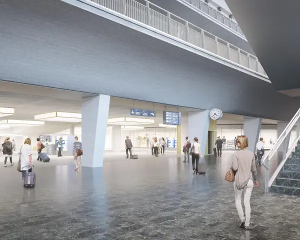 Modern, spacious interior of the Lucerne train station with travelers and digital departure boards.