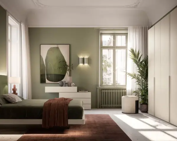 Camera da letto con pareti verdi e un letto accogliente. L'arredamento verde crea un'atmosfera rilassante, con un quadro astratto e un grande armadio bianco.