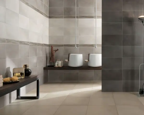 Bagno moderno con lavabi bianchi sospesi, ideale per chi cerca idee su come rivestire un bagno con stile e funzionalità.