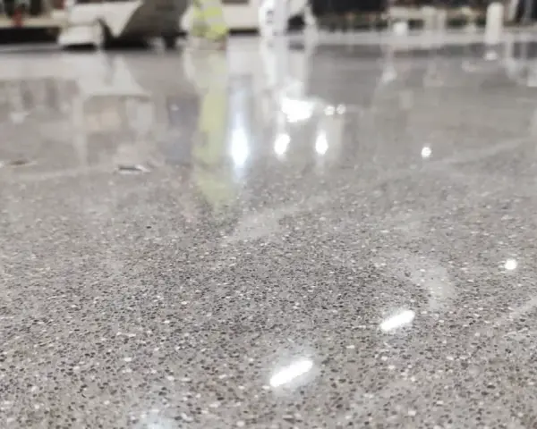 Gładka, polerowana posadzka betonowa z widocznymi kruszywami. Idealny wybór, jeśli zastanawiasz się, jaki beton na posadzkę wybrać do nowoczesnych wnętrz.