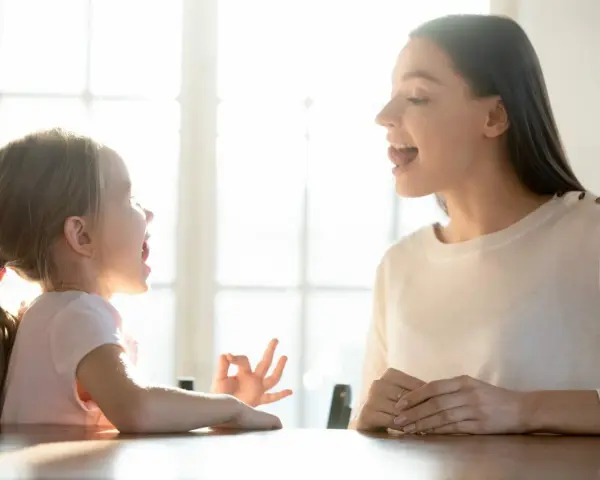 Mama uczy córkę mówić, a dziecko zaczyna rozumieć co się do niego mówi.