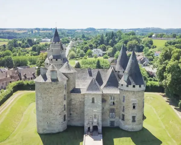 Le château de Bonneval, un joyau médiéval, se dresse fièrement au milieu d'un paysage verdoyant, entouré d'un village pittoresque.