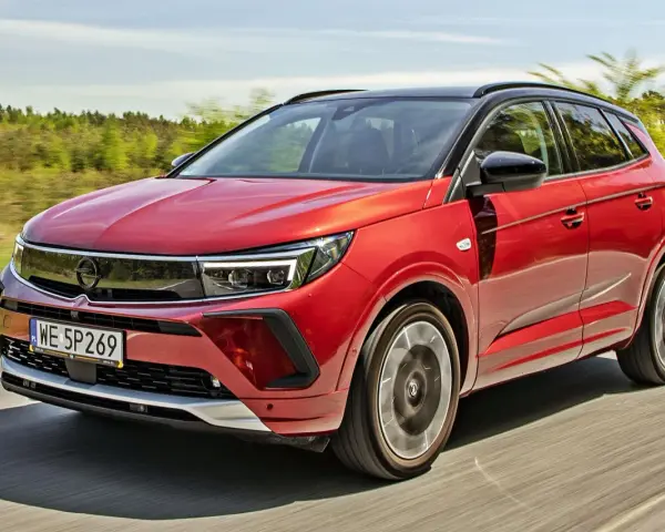 Czerwony Opel Grandland na drodze, idealny do sprawdzenia jego opel grandland cena.