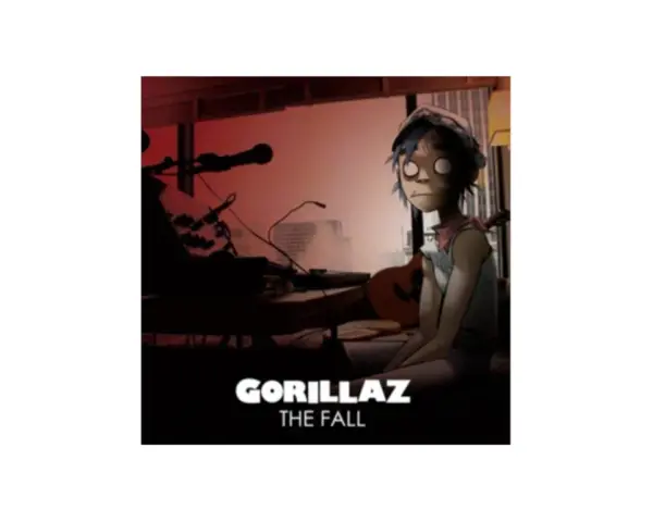 Okładka albumu Gorillaz The Fall. 2D siedzi przy stole z gitarą i sprzętem muzycznym.